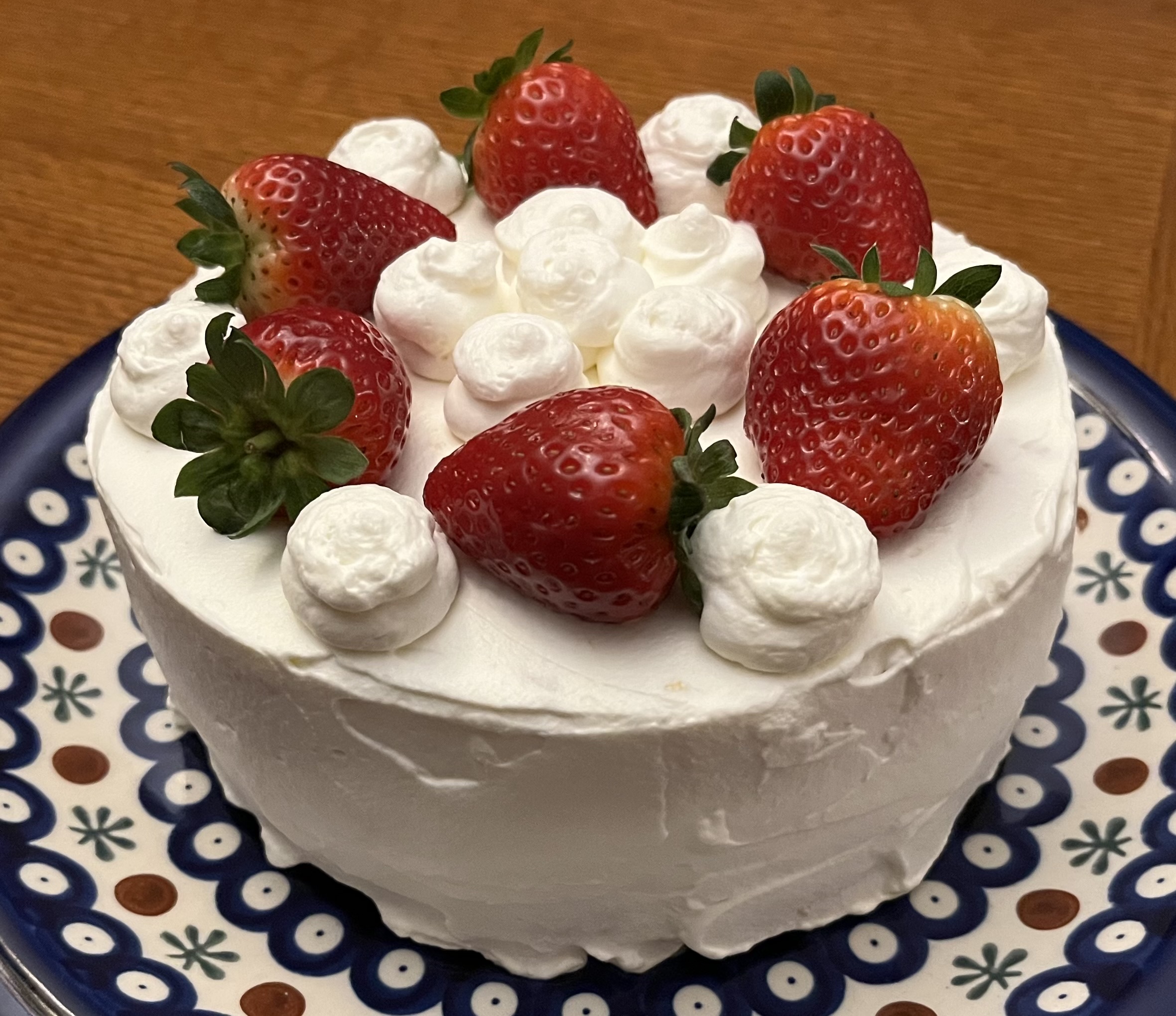 cake (finished, with strawberries and puffs of whipped cream on top)